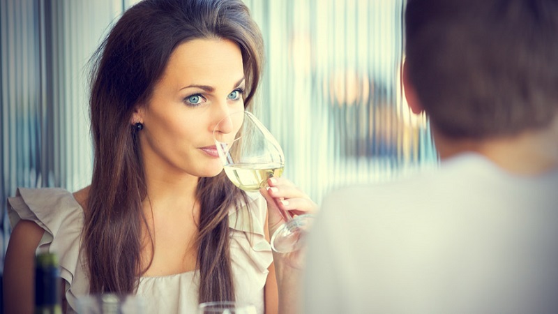 girl-drinking-her-wine-and-watching-her-guy